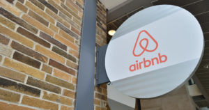 image of airbnb's logo on a brick facade