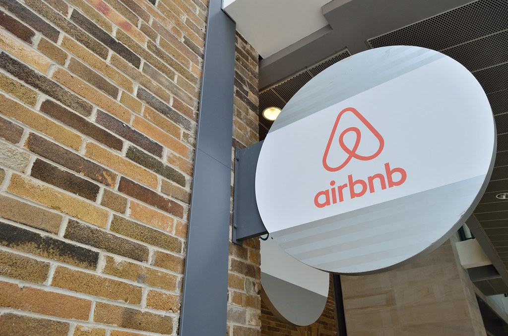 image of airbnb's logo on a brick facade